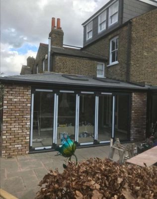 Extension Kitz external image partially built. apex roof and bi fold doors in place.